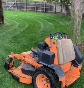 Scag mower just finished mowing homeowner's lawn at Tiger Stripe Lawn Care